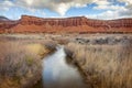 Fremont River Flowing Under Red Sandstone Cliff. Royalty Free Stock Photo